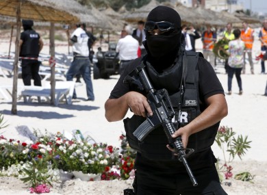A policeman stands guard at the scene of the terrorist attack a few days after 38 people were killed