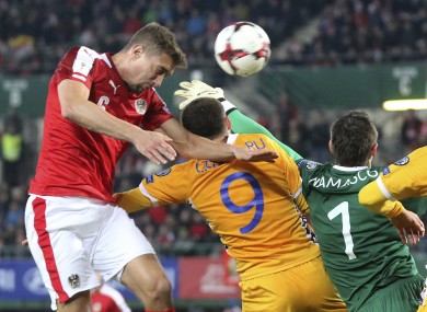 Austria's Stefan Ilsanker batttes Eugeniu Cebotaru, Stanislav Namasco and Alexandru Gatacan for the ball.