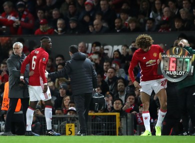 Jose Mourinho pats Manchester United's Paul Pogba on the back after the player is forced to leave the pitch with an injury.