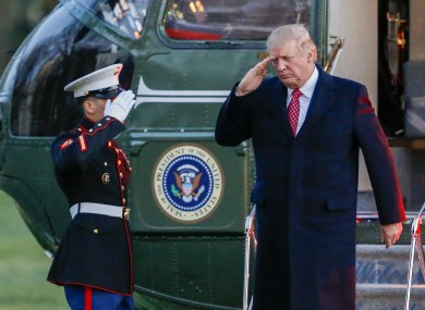 Trump salutes as he disembarks Marine One on the South Lawn of the White House.