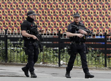 Armed police keep guard near Victoria Station in Manchester.