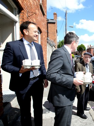 Leo Varadkar and Paschal Donohoe arrive on Leo Street this morning with coffee for the assembled press.