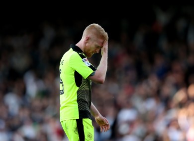 McShane walks off the pitch after his red card.