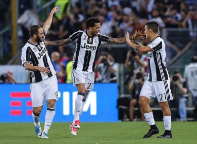 Juventus' Dani Alves (centre) celebrates with his teammates Paulo Dybala, right, and Gonzalo Higuain.