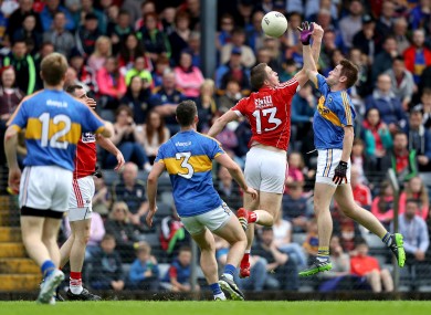 Colm O'Neill and Bill Maher battle for the ball.
