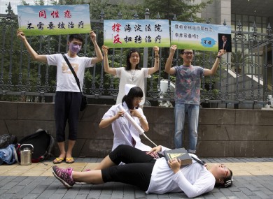 Gay rights campaigners act out electric shock treatment to protest so-called conversion therapy.