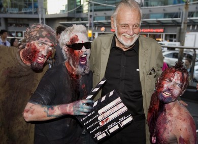 George Romero poses with some fans dressed as zombies after accepting a special award during the 2009 Toronto International Film Festival in Toronto.