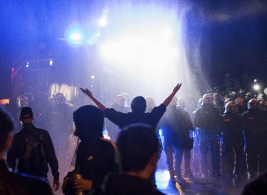 A water cannon sprays water onto demonstrators who block the traffic in Hamburg, northern Germany.