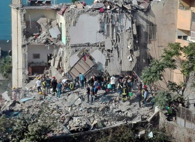 Rescuers work amid the rubble the collapsed building near Naples.