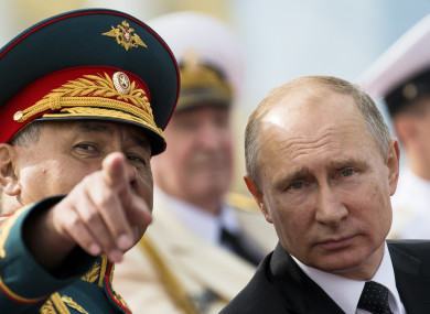 Russian President Vladimir Putin, right, listens to Defence Minister Sergei Shoigu .