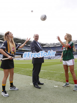 Minister for Communications, Climate Action and Environment, Denis Naughten TD at the photo-call with (LtoR) Miriam Frisby from Kilkenny Camogie and Sarah Rowe from Mayo Gaelic Football.