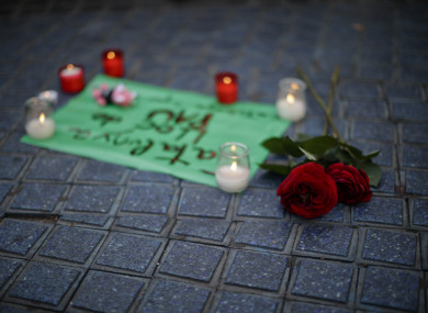 Flowers and candles placed on the pavement at Las Ramblas