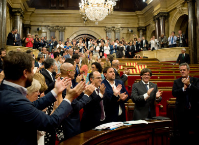 Pro-independence members of the Catalan parliament celebrate after last night's meeting.