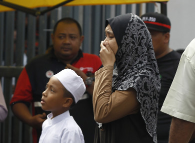 A woman cries outside the school.