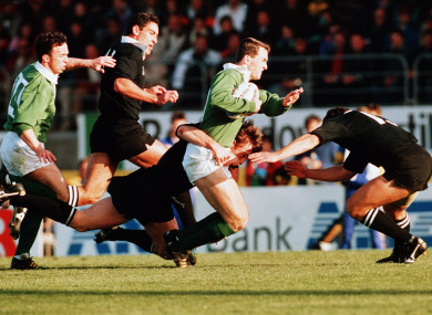 Furlong is tackled by the All Blacks.