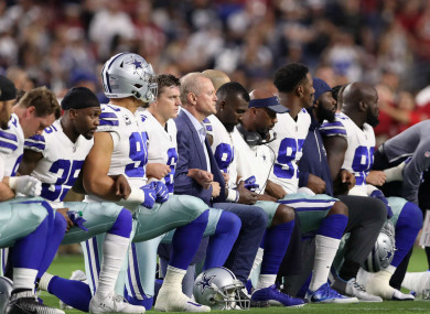 Cowboys kneeling before the US national anthem.