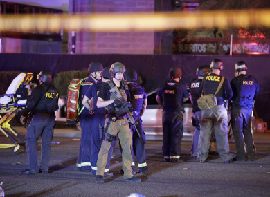 Police officers stand at the scene of the shooting