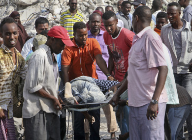Somalis remove the body of a man killed in the blast.