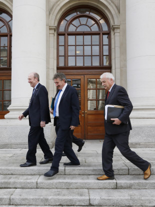 Transport Minister Shane Ross, John Halligan and Finian McGrath on the steps of government buildings.