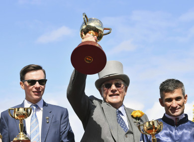 From left, trainer Joseph O'Brien, owner Lloyd Williams, and jockey Corey Brown pose with their winning trophies after Rekindling wins the Melbourne Cup at Flemington Racecourse.