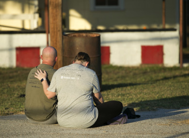 A couple comfort each other at a community centre in Sutherland Springs