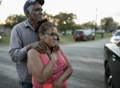 Enrique and Gabby Garcia watch investigators at the scene.