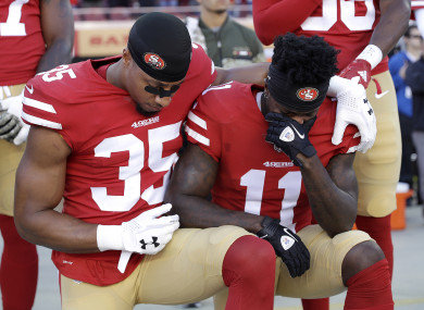 An emotional Goodwin (11) kneels during the US national anthem yesterday.