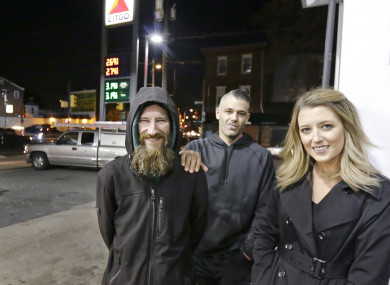 Johnny Bobbitt Jr., left, Kate McClure, right, and McClure's boyfriend Mark D'Amico pose at a Citgo station in Philadelphia.