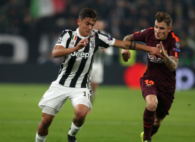 Juventus Paulo Dybala and Barcelona's Lucas Digne battle for the ball.