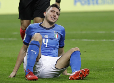 Italy's Matteo Darmian grimaces after colliding with a Swedish player.