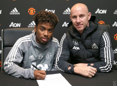 Gomes signs with United's head of academy Nicky Butt.