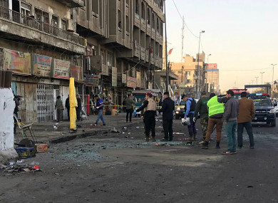 Iraqi security forces gather at the scene of a double suicide bombing in Baghdad, Iraq.