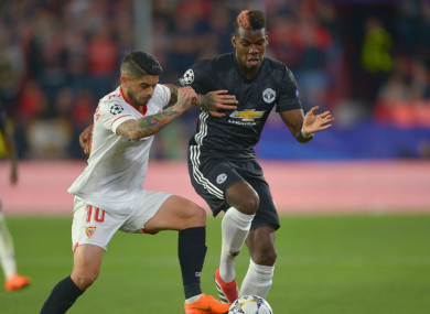 Sevilla midfielder Ever Banega and Paul Pogba of Manchester United.