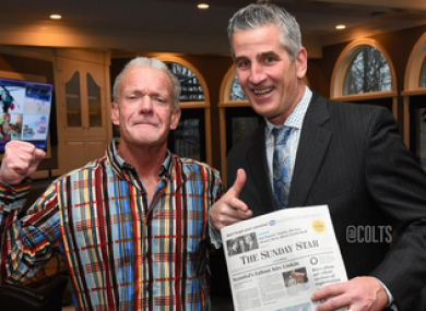 Reich poses with a newspaper next to Colts' owner Jim Irsay to prove he has really signed on.