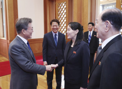 South Korean President Moon Jae-in, left, shakes hands with Kim Yo Jong, North Korea leader Kim Jong Un's sister
