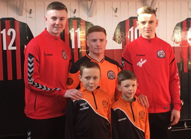 Steven Nolan, Jamie Hamilton and Darragh Leahy with St Kevin's Boys youngsters Michael and Zach.