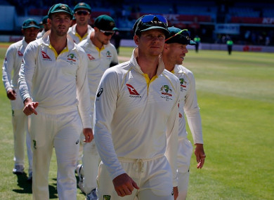 Australia's captain Steve Smith (centre) leads his team alongside David Warner (right).
