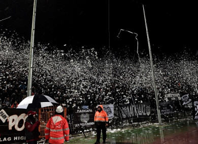 Paok's supporters throw toilet rolls and other projectiles prior to the Greek Superleague match against Olympiakos.