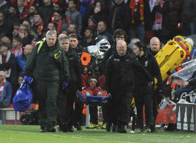 Liverpool's Alex Oxlade-Chamberlain is carried on a stretcher after getting injured.
