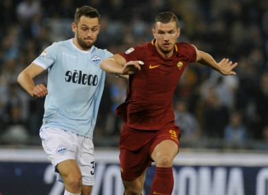 Lazio's Stefan De Vrij battles with Roma striker Edin Dzeko.