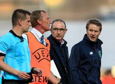 Republic of Ireland senior manager Martin O'Neill and Under 17 manager Colin O'Brien speak with referee Zbynek Proske after the match.