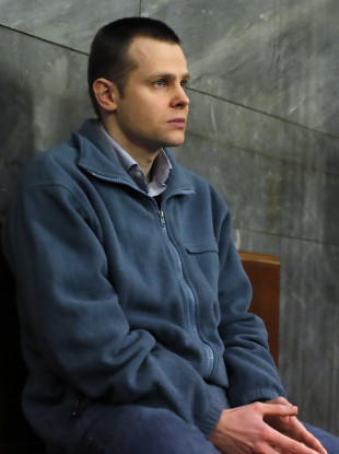 Lukasz Herba sits at a Milan court in Italy during his trial.