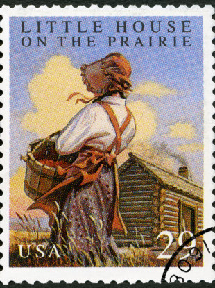 A stamp printed in USA shows Little House on the Prairie by Laura Ingalls Wilder - File photo