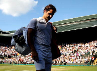 Roger Federer walks off court after losing to Kevin Anderson
