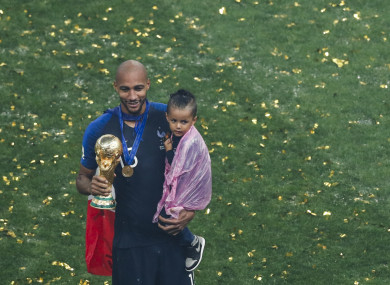 N'Zonzi holds the World Cup trophy and his child.