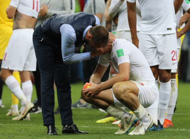 England's head coach Gareth Southgate (L) comforts Harry Maguire.