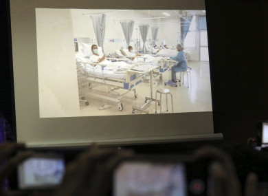 Members of the media try to photograph a projected image of the rescued boys in their hospital room during a police press conference in Chiang Rai province, northern Thailand.
