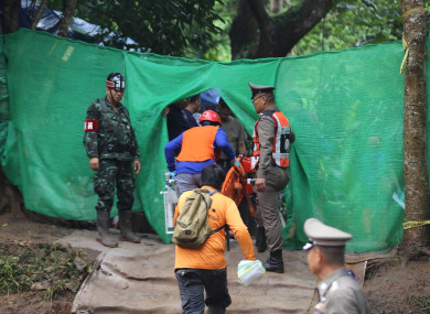 Rescuers work near the cave where the young soccer team members and their coach were trapped in Chiang Rai, Thailand