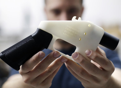 Cody Wilson, with Defense Distributed, holds a 3D-printed gun called the Liberator at his shop in Austin, Texas