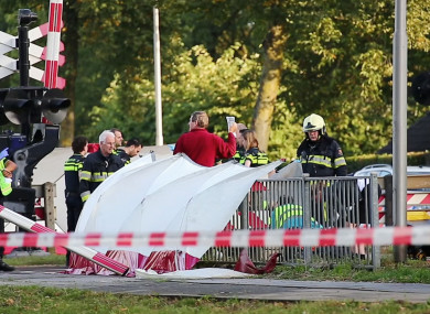 Emergency services attend the scene after a train collided with a cargo bike in the town of Oss